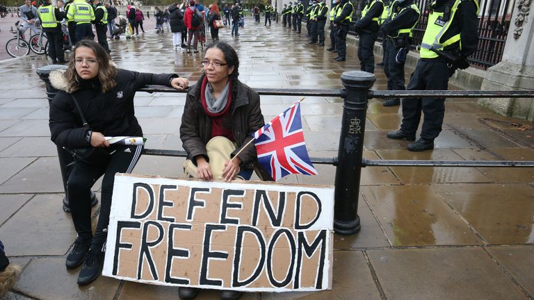 Protesters sit in front of a police ramp outside Buckingham Palace