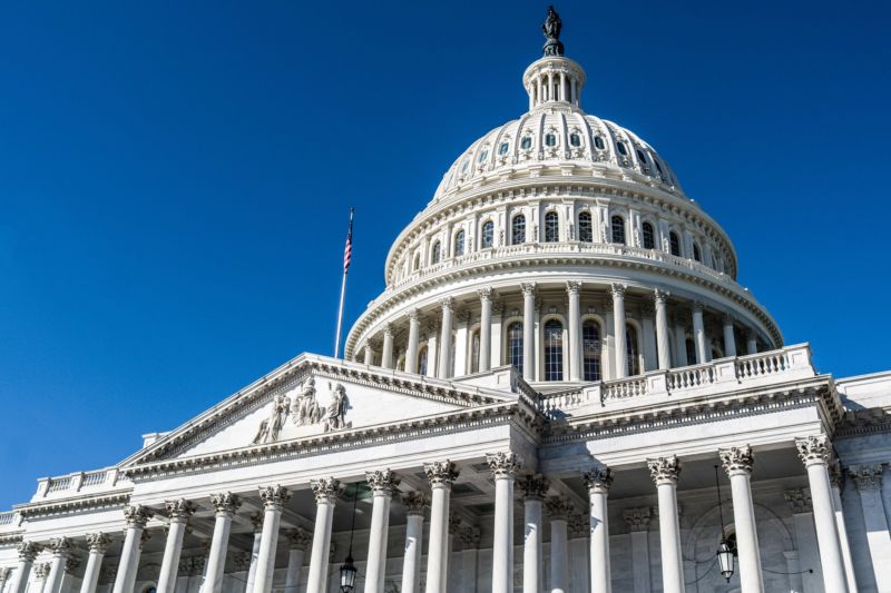 The dome of the United States Capitol building against the deep blue sky in Washington D.C.