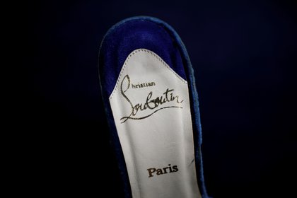 Christian Louboutin made the shoe with a red sole and its distinctive feature (Reuters) 