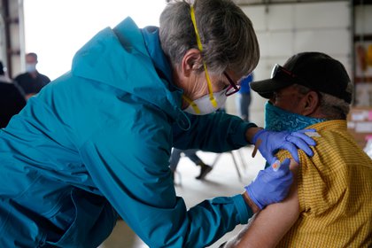 Registered nurse Pat Heinen gives Gennard Chavez his vaccine against the Coronavirus Disease (COVID-19) at a rural vaccination site in Columbus, New Mexico, USA, April 16, 2021 (Reuters / Paul Ratgi)
