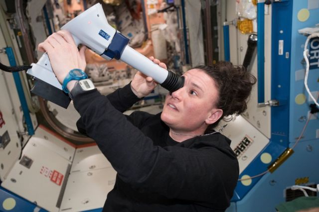 Astronaut Serena Onion looks into the International Space Station with her eyes