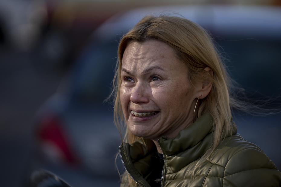 A woman cries when she sees the damage to her apartment from a Russian army attack.