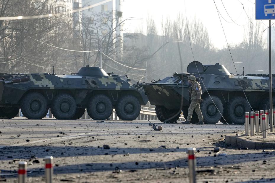 A soldier walks past Ukrainian armored vehicles forming a barricade on a street in Kiev, Ukraine.