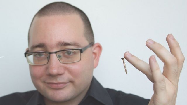 Patrick Bowmen shows a magnetic nail on his finger