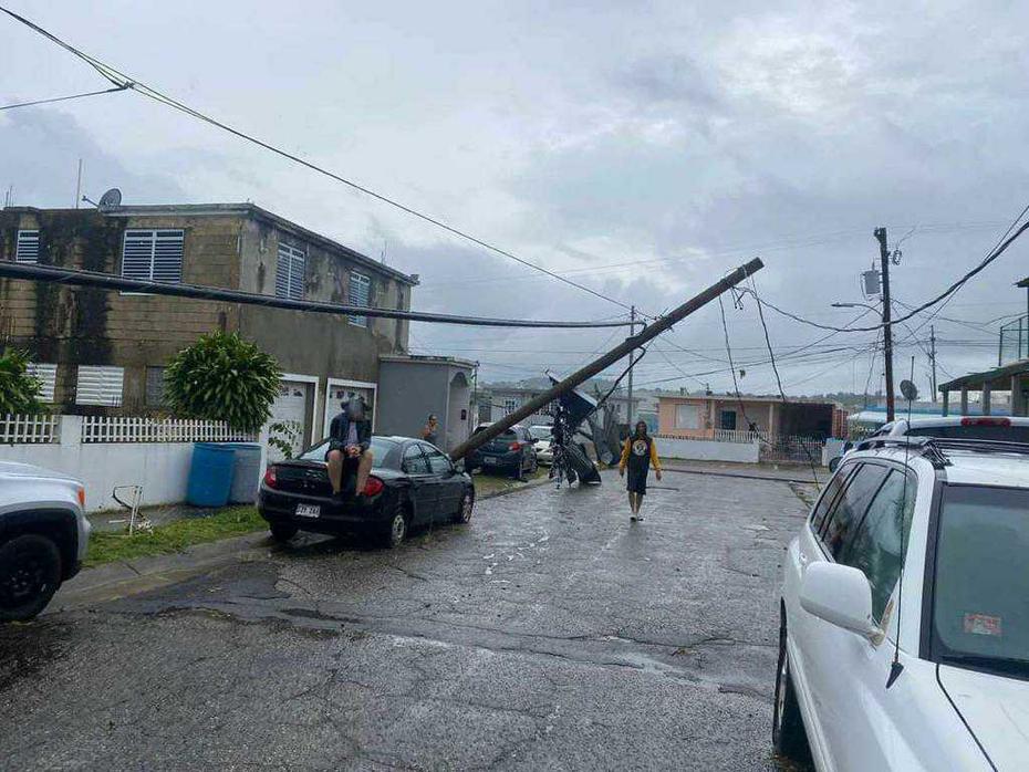 A utility column falls due to strong hurricane winds.