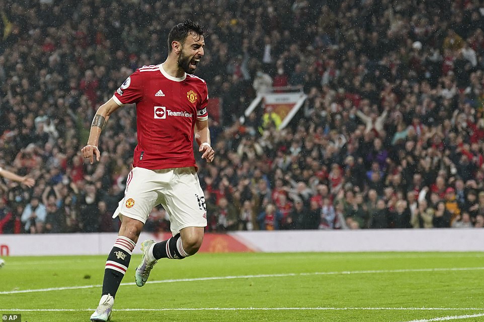 The Portuguese midfielder celebrates in front of the United fans after opening the scoring in the ninth minute