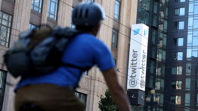 A cyclist passes the Twitter offices in California