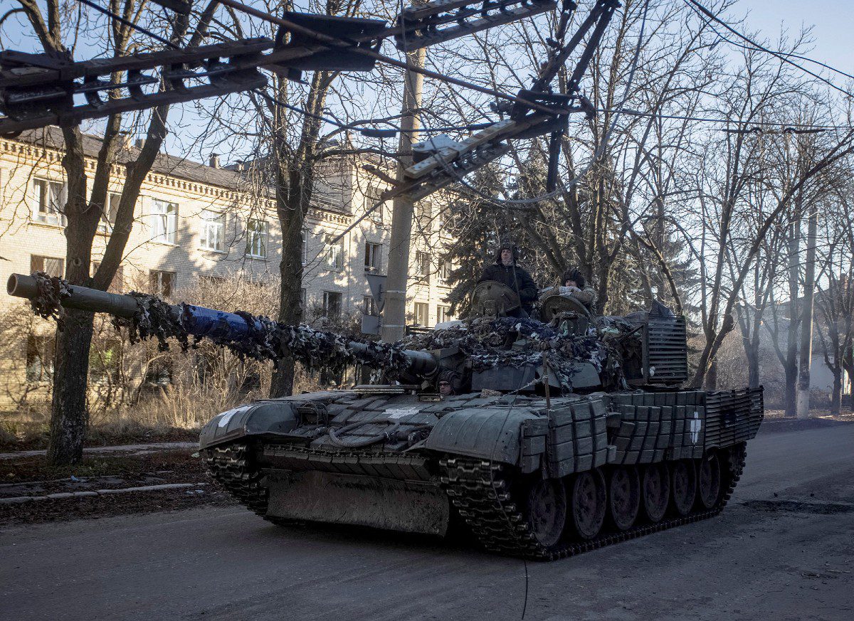 Ukrainian soldiers ride on a tank in Bakmut, Donetsk region, Ukraine on December 5.  (Yevhen Titov/Reuters) 